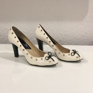 Michael Kors Ivory pumps with Gold grommets.